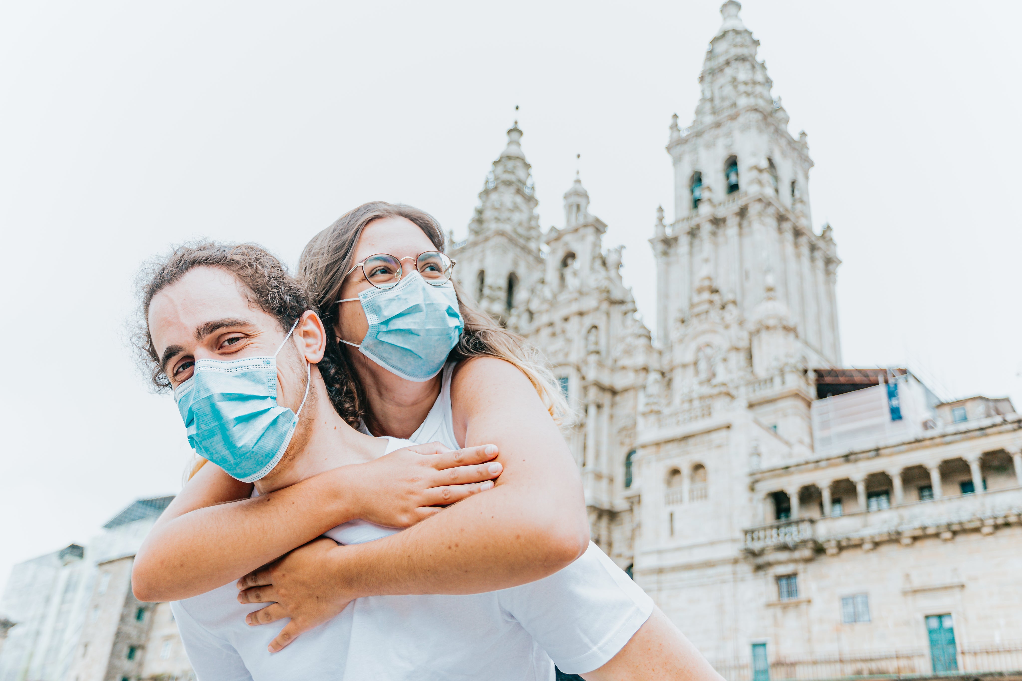 files/woman-hugs-man-from-behind-while-wearing-blue-facemask.jpg